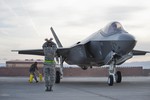 File - U.S. Air Force 57th Wing Lightning Aircraft Maintenance Unit crew chiefs marshals an F-35 Lighting II aircraft at Nellis Air Force Base, Nev., March 6, 2013.