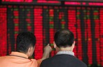 Investor look at the stock price monitor at a private securities company Wednesday June 24, 2009, in Shanghai, China.