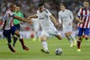 Real Madrid's James Rodriguez from Colombia duels for the ball with Atletico Madrid's Joao Miranda from Brazil