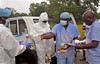 Health workers are handed personal protective gear by a team leader, right, before collecting the bodies of the deceased from streets in Monrovia, Liberia, Saturday, Aug. 16, 2014. New figures released by the World Health Organization showed that Liberia has recorded more Ebola deaths  413  than any of the other affected countries.