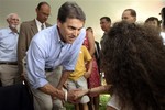 Republican presidential candidate Texas Gov. Rick Perry meets guests at a house party, Saturday, Sept. 3, 2011 in Chichester, N.H.