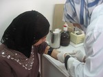 A young Palestinian receives treatment in a UNRWA clinic in Jebel Al Hussein refugee camp in Amman