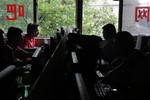 In this July 14, 2010 file photo, Chinese use computers at an Internet cafe in Beijing. The news agency of China's ruling Communist Party launched an Internet search site Tuesday, Feb. 22, 2011, giving its own sanitized view of the Web following Google's closure of its China-based search engine last year over censorship.