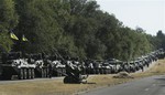 Ukrainian soldiers park their hardware on the roadside as they wait for the start of the march into the town of Mariupol, eastern Ukraine, Wednesday, Aug. 27, 2014.