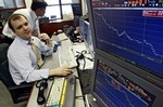 A Russian trader looks at a display showing Yukos shares' plunge at the Troika Dialog trading company in Moscow, Wednesday, July 28, 2004. Russia's largest oil producer Yukos' shares plunged Wednesday nearly 14 percent in Moscow trading, the third straight day of precipitous falls for the troubled company's stock. (AP Photo/ Sergey Ponomarev)hg3 