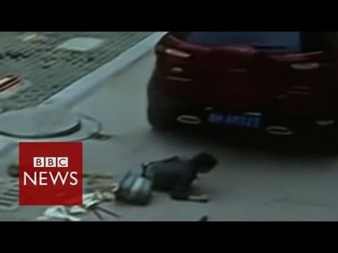 Chinese boy unhurt after car runs over him - BBC News