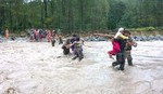 Indian Army soldiers rescue flood- stranded people using a rope across a stream in Jammu on Saturday 06, September 2014.