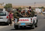 Kurdish forces, known as the Peshmerga, make their way to the front line to fight militants from the extremist Islamic State group at Mosul Dam, outside Mosul, Iraq, Monday, Aug 18, 2014. Boosted by two days of U.S. airstrikes, Iraqi and Kurdish forces on Monday wrested back control of the country's largest dam from Islamic militants, a military spokesman in Baghdad said, as fighting was reported to be underway for the rest of the strategic facility.