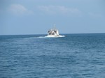 Ferry ship seen in the clear blue sea water - Goa