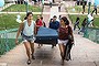 Emma Sulkowicz (L), a senior visual arts student at Columbia University, carries a mattress in protest of the university's lack of action after she reported being raped