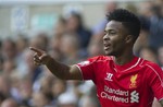 Liverpool's Raheem Sterling celebrates after scoring against Tottenham Hotspur, during their English Premier League soccer match at White Hart Lane, London, Sunday, Aug. 31, 2014