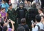 File - People take photos of Thai special forces officers during an event called 'Return Happiness to Thai People' at Bangkok's Victory Monument in Thailand Wednesday, June 4, 2014.