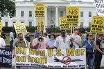 File - People gather outside of the White House in Washington, Saturday, June 21, 2014, to protest against renewed U.S. involvement in Iraq.