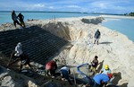 File - Workers build a landfill on Tarawa atoll, Kiribati, March 30, 2004.