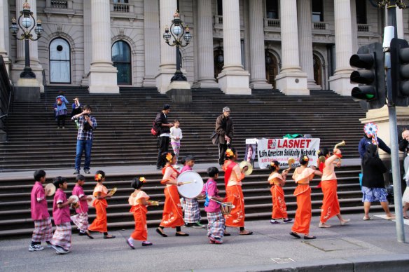 Buddhists passing in front of LASNET banner