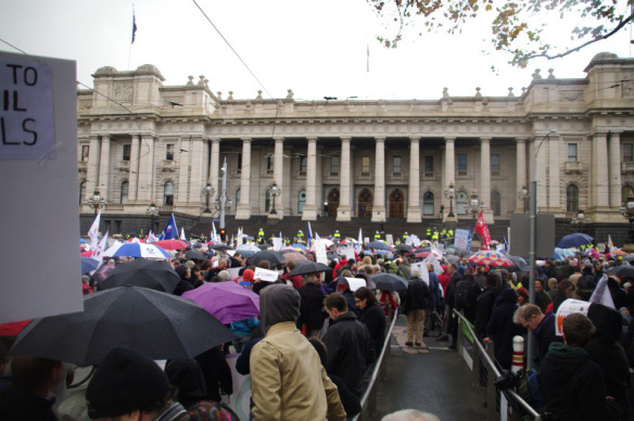 Looking over head and brollies towards Parliament House