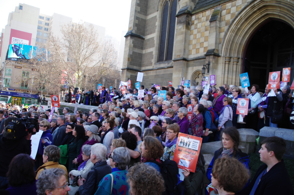 Group on steps singing We Shall Overcome