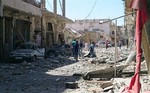 This image posted by the Raqqa Media Center of the Islamic State group, a militant extremist group, which has been authenticated based on its contents and other AP reporting, shows Syrians inspecting the rubble of a damaged houses following a Syrian government airstrike in the northeastern city of Raqqa, Syria, Saturday, Sept. 6, 2014.