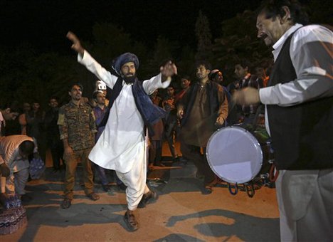 Supporters of Afghan presidential candidate Ashraf Ghani Ahmadzai celebrate with music and dancing near his residence after he was named the winner and next president by the Afghan election commission, in Kabul, Afghanistan, Sunday, Sept. 21, 2014