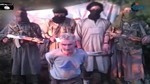 In this still image from video published on the Internet on Wednesday, Sept. 24, 2014, by a group calling itself Jund al-Khilafah, or Soldiers of the Caliphate, members of the group stand behind French mountaineer Herve Gourdel just before beheading him. In the video, the men pledge their allegiance to the leader of the Islamic State group, Abu Bakr al-Baghdadi, before killing Gourdel, 55, who they abducted on Sunday, Sept. 21.