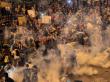 Protesters in Hong Kong flee tear gas