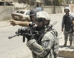 File - U.S. Army Soldiers with 4th Platoon, Delta Company, 2nd Battalion, 12th Infantry Regiment, 2nd Brigade Combat Team, 2nd Infantry Division out of Fort Carson, Colo., and Iraqi national police search for anti-coalition forces in the area of Dora in southern Baghdad, Iraq, July 23, 2007.