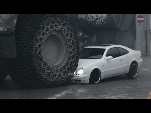 Car Being Crushed by Big Excavator