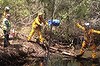 Firefighters help paramedics access the crash site.