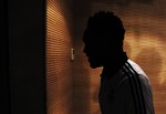 New Real Madrid soccer player Michael Essien from Ghana leaves the press conference room after his official presentation at the Bernabeu stadium in Madrid on Saturday, Sept. 1, 2012.