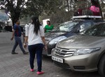 A woman stopping at a parking place-India.