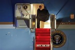 President Barack Obama closes his umbrella as he boards Air Force One, at Philadelphia International Airport, Tuesday June 12, 2012, after attending an event in Philadelphia