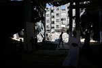 A Palestinians inspect the destruction in Farouq Mosque after an Israeli air strike, in Rafah at the Southern Gaza Strip on July 22, 2014. Israeli army warns residents to evacuate their homes immediately. Israel kept up its assaults in the Gaza Strip, as U.S. Secretary of State John Kerry arrived in the region with a mission to seek a ceasefire in the 14-day-old conflict "as soon as possible. Photo by Ahmed Deeb/WN