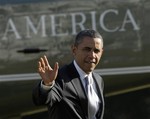 President Barack Obama waves as he walks off of Marine One on the South Lawn of the White House in Washington, Friday, Jan. 27, 2012.