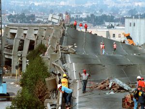 In this Oct. 19, 1989 file photo, Workers check the damage to Interstate 880 in Oakland, Calif., after it collapsed during the Loma Prieta earthquake two days earlier.