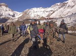 In this photo provided by the Nepalese army, soldiers carry an avalanche victim before he is airlifted in Thorong La pass area, Nepal, Wednesday, Oct. 15, 2014.