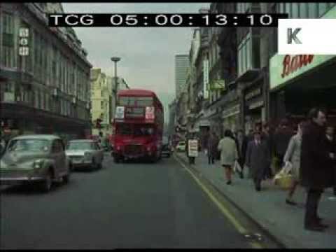 Drive along late 1960s Oxford Street, Central London, Shopping