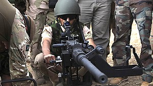 A Kurdish Peshmerga fighter undergoes training by British soldiers at a shooting range in Arbil, in Iraq's northern autonomous Kurdistan region, October 16, 2014.