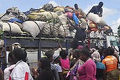 Women gathered as people offload food from a truck at a market in Monrovia, Liberia. Saturday, Oct. 18, 2014.=