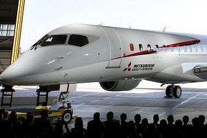 The Mitsubishi Regional Jet (MRJ) passenger aircraft is unveiled during a rollout ceremony.