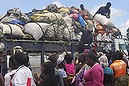 Women gathered as people offload food from a truck at a market in Monrovia, Liberia. Saturday, Oct. 18, 2014.=