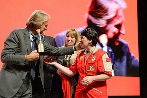 Luca di Montezemolo is presented with a figurine of himself by Ferrari staff during a farewell ceremony in Maranello