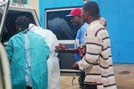 File - Health workers in Monrovia, during the visit of Hervé Ladsous, UN Under-Secretary-General for Peacekeeping Operations, to assess how the UN Mission in Liberia (UNMIL) can further support the fight against Ebola, 11 September, 2014.