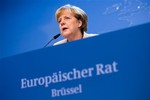 German Chancellor Angela Merkel speaks during a media conference after an EU summit at the EU Council building in Brussels, on Friday, Oct. 24, 2014.