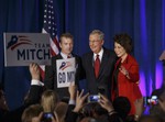 Senate Minority Leader Mitch McConnell, R-Ky., center, celebrates with Sen. Rand Paul, R-Ky., left, and his wife, former Labor Secretary Elaine Chao, at an election night party in Louisville, Ky.,Tuesday, Nov. 4, 2014.