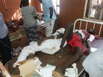 People are treated at the General hospital in Potiskum, Nigeria, Monday, Nov. 10, 2014, following a suicide bomb attack at Government Science Technical College Potiskum.