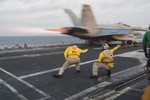 Capt. Walt Slaughter, left, executive officer of the aircraft carrier USS Carl Vinson (CVN 70), and Lt. Ramses Leon, shoot off an EA-18G Growler from the Cougars of Electronic Attack Squadron (VAQ) 139 off the flight deck of Carl Vinson, 1 November, 2014.