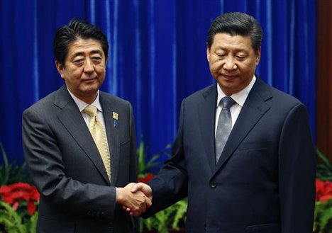 China's President Xi Jinping, right, shakes hands with Japan's Prime Minister Shinzo Abe, during their meeting at the Great Hall of the People, on the sidelines of the Asia Pacific Economic Cooperation (APEC) meetings, in Beijing, Monday, Nov. 10, 2014.