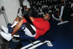 Operations Specialist 3rd Class Reginald Sanders strengthens his abdominal muscles on a decline bench.