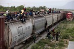 File - In this Saturday, July 12, 2014, photo, central American migrants ride a freight train during their journey toward the U.S.-Mexico border in Ixtepec, Mexico.