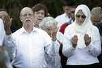 File - Ed Kassig, left, and wife Paula pray during a vigil for their son Abdul-Rahman Kassig, who last week was named the next beheading target of the Islamic State terror group, at Butler University in Indianapolis, Wednesday, Oct. 8, 2014.